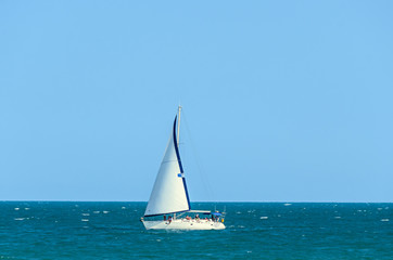 Naklejka premium ALBENA, BULGARIA - JUNE 17, 2017: Wind boat yacht on blue Black Sea water near beach