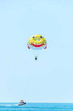 ALBENA, BULGARIA - JUNE 15, 2017: Colored parasail wing pulled by a boat in the sea water, Parasailing also known as parascending or parakiting