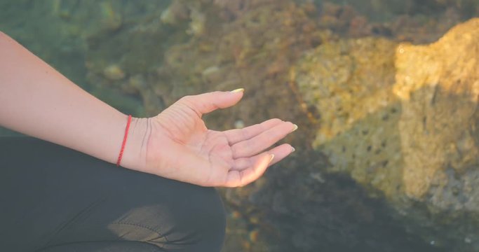 Finger mudras near the sea