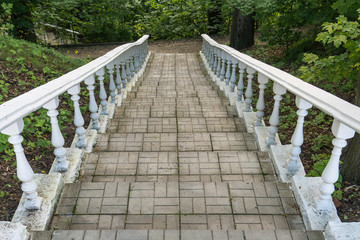 A staircase with a balustrade in the park.