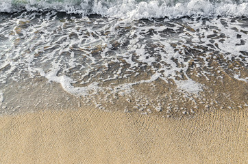 The Black Sea beach with golden sands, foam water, ocean shore