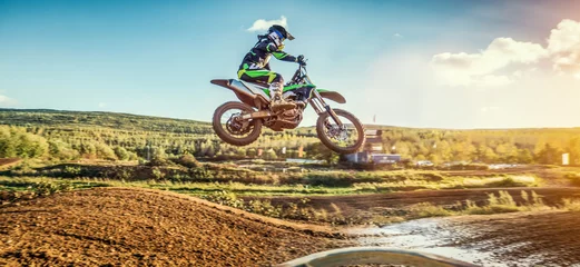 Fototapeten Extreme Motocross MX Rider riding on dirt track © AA+W