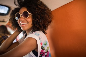 Young woman wearing sunglasses in camper van