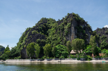 Soaring limestone cliffs in Inland Haolong Bay, Ninh Binh, Vietnam.