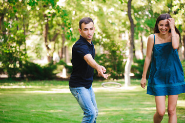 Guy and girl compete in the ring toss