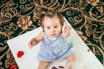 Happy little child, adorable creative toddler girl playing with dough, colorful modeling compound