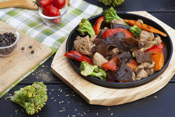 Beef meat with vegetables in a frying pan, Asian cuisine