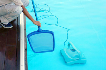 Fototapeta na wymiar Pool cleaner during his work
