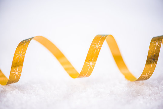 Christmas festive golden ribben in snow
