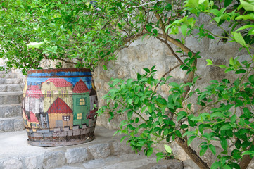 An old barrel with painted houses.