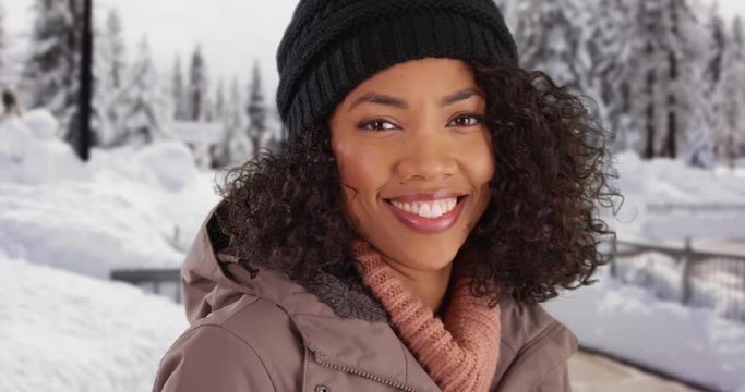 Close Up Of Cute Black Female Outdoors In Snow Smiling At Camera 