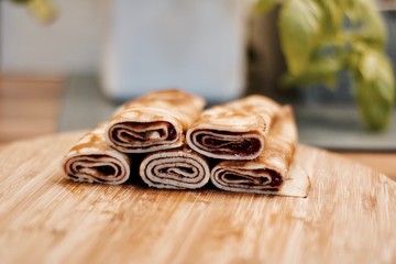 Tasty pancakes on the wooden board