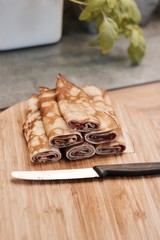 Tasty pancakes on the wooden board