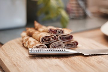 Fototapeta na wymiar Tasty pancakes on the wooden board