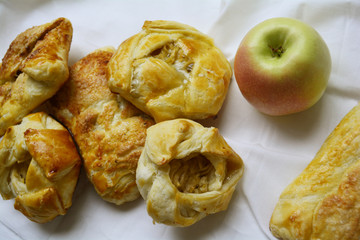 sweet rolls, rolls of flaky pastry with Apple filling on the table, a treat for tea