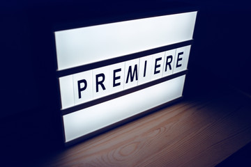 Vintage illuminated Premiere sign in cinema movie
