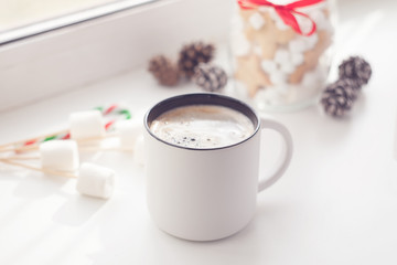 Coffee and christmas decoration on window