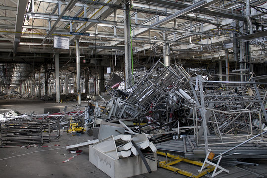 zerstörte Industriehalle mit herumliegenden Materialien wartet auf den Abriss