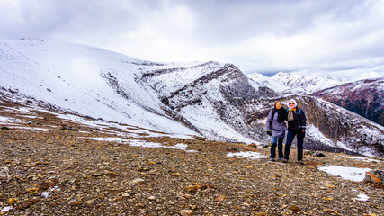 Fototapeta premium Two women on the Whistlers mountain in Jasper National Park surrounded by snow covered peaks in the Canadian Rocky Mountains