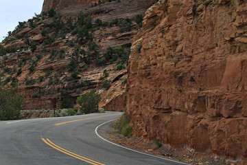 Mountain curve thru solid red rock 