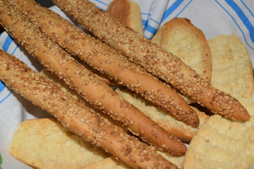 basket with bread and grissini with sesame