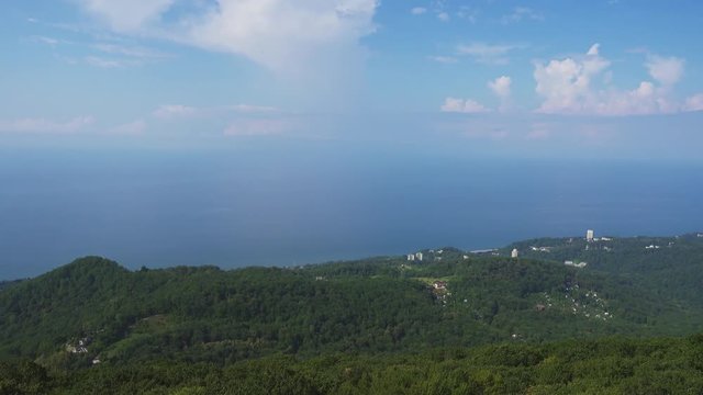 Panorama of resort city Sochi on the Black Sea among the Caucasus Mountains, aerial view 4k
