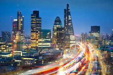 City of London at sunset and traffic blur lights on busy roads. Technology, transformation and...