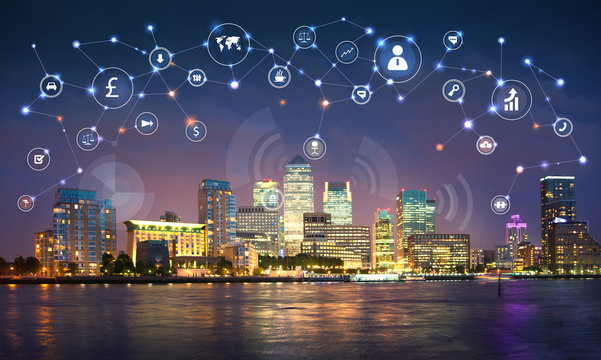 Modern skyscrapers of  Canary Wharf in the night and business network connections. Illustration made with many communication icons. Technology, transformation and innovation idea. 