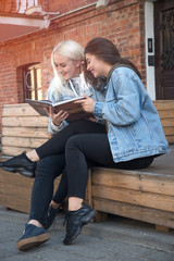 two friends reading a book
