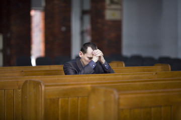Man praying in Catholic Church