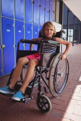 Fototapeta na wymiar Portrait of student sitting on wheelchair in corridor