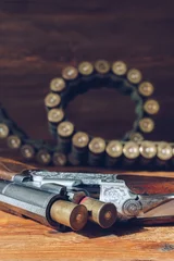 Acrylic prints Hunting Hunting equipment. Shotgun and hunting cartridges  on wooden table.