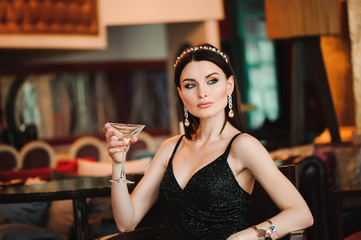 Portrait of beautiful woman holding glass of martini