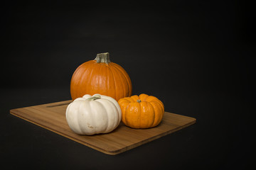 Three pumpkins on a cutting board - focus stacked