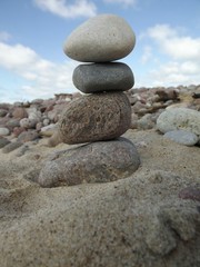 Fototapeta na wymiar Tower from four stones in the beach