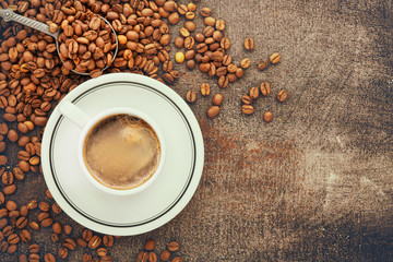 Coffee cup and beans on old kitchen table. Top view with copyspace for your text