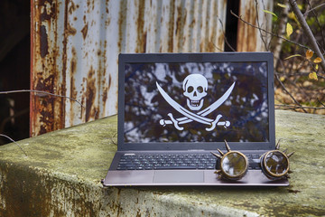 Laptop with a picture of a pirate flag 