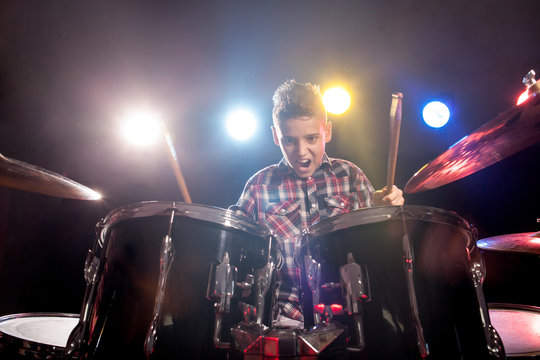 young boy playing drums