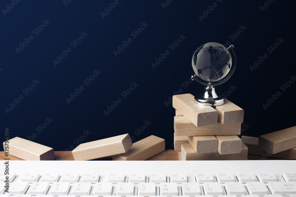 Wall mural global glass with wood building block and white keyboard in business vision concept