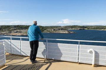 adult man in blue sweater on ferry