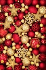 Christmas gold and red bauble decorations forming an abstract background.