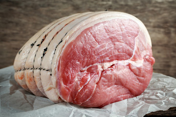 Raw whole green gammon a piece in a crumpled paper