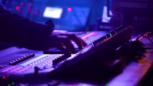 View in motion of sound engineer working on his workplace