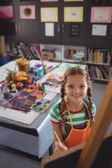 High angle portrait of girl painting on canvas