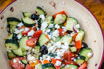 Fresh healthy Greek Salad.  Nutritious and delicious filled with vegetables, cheese and herbs. Perfect side dish, appetizer or meal.