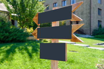Blank wooden arrows direction (road) sign with ..spiderweb, copy space. Empty wedding ceremony signs, free space