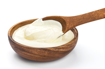 Sour cream in wooden bowl isolated on white background