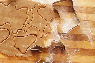 Homemade gingerbread cookies, forms and baking ingredients.