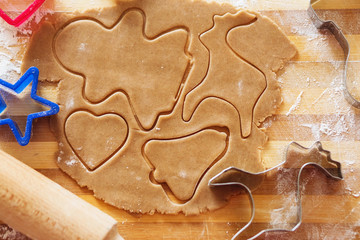 Homemade gingerbread cookies, forms and baking ingredients.