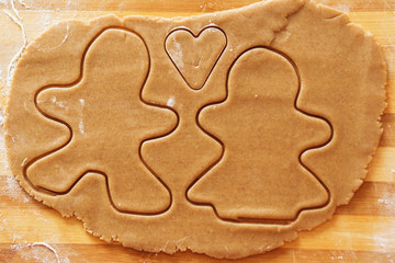 Homemade gingerbread cookies, forms and baking ingredients.